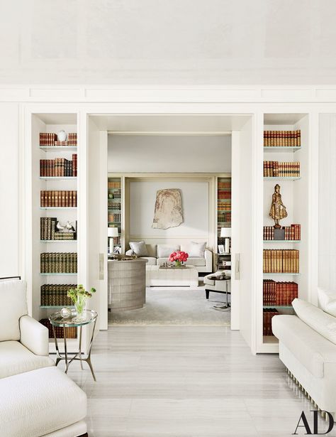 A view into the library, where a Bartolomeu Cid dos Santos stone relief is displayed above the sofa; the small table in the foreground is by Holly Hunt. Home Library Design, Home Libraries, Hus Inspiration, Home Library, Book Shelf, A Living Room, Architectural Digest, Built Ins, تصميم داخلي