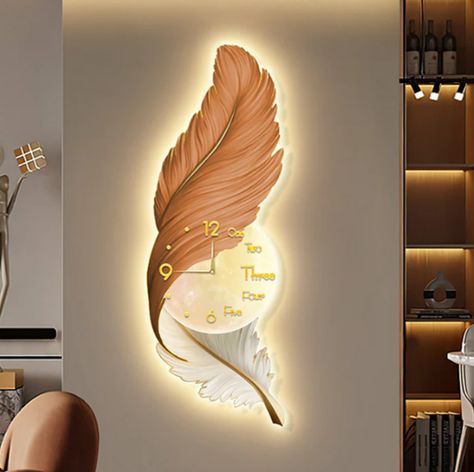 Add a touch of elegance and nature to your home with our Bella Donna Feather Wall Clock + Light. This decorative clock + light fixture is shaped like a large feather and accented with a glamorous gold details. #lightfixture #wallclock #lightfixtures #clocks Wall Clock Art Deco, Living Room Wall Clock, Wall Clock Light, Modern Wall Clock, Wall Clock Design, Feather Wall, Clock Art, Wall Decor Design, Large Clock