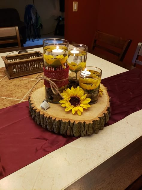 Mockup for barn wedding. Sunflower and burgundy centerpieces on wood round Sunflower And Burgundy Wedding, Burgundy Centerpieces, Burgundy Centerpiece, Wedding Cakes Maroon, Fall Sunflower Weddings, Burgundy Wedding Centerpieces, Sunflower Wedding Decorations, Rustic Sunflower Wedding, Sunflower Centerpieces