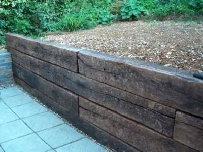 railway sleeper retaining wall - Google Search Railroad Tie Retaining Wall, Sleeper Wall, Sleeper Retaining Wall, Sleepers In Garden, Wood Retaining Wall, Retaining Wall Design, Building A Retaining Wall, Garden Retaining Wall, Railway Sleepers