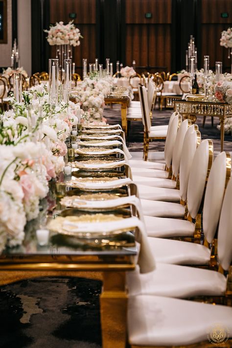 Alex & Rami’s wedding reception at The Post Oak Hotel featured our curved gold and white table wrapped around the luxurious dance floor, complemented by white and gold chairs. Dramatic table centerpieces included a mix of crystal and white floral bridges, lush floral table runners, and tall candle towers, creating a breathtaking ambiance. | Floral, Decor, Production & Design: Royal Luxury Events / Photo: MaxAnthony Studios | wedding seating, wedding chairs, wedding reception ideas, luxe wedding Wedding White And Gold, Royalty Wedding Theme, Gold And White Table, Gold And Blush Wedding, Dramatic Table, Luxury Event Decor, Circle Dining Table, Gold Chairs, White Dining Chair