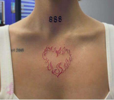 Fire Heart Tattoo On Upper Chest Lover Chest Tattoo, Heart With Crown Tattoo Ideas, Tattoo On Upper Chest, Fireheart Tattoo, Burning Heart Tattoo, Fire Heart Tattoo, Heart Chest Tattoo, Tattoos With Deep Meaning, Red Heart Tattoos