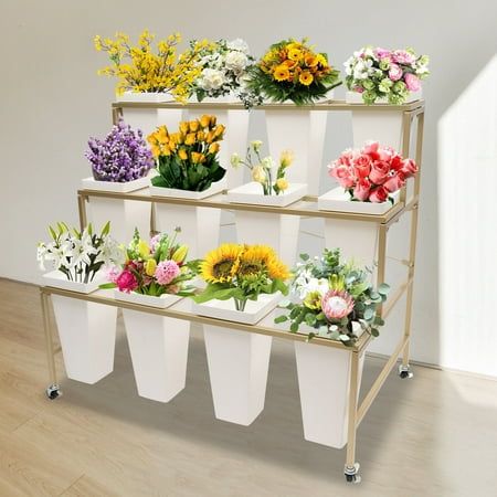 This package is a flower display stand with 12 flower buckets that can hold many different flowers in different categories. No matter home or commercial, it can meet your needs very well. Moreover, the gold baking paint looks very shiny and luxurious. It is the most ideal choice for displaying your flower. Details Deep Buckets:All 12 buckets are 13.39inch high, which is deep enough to hold long rhizomes and keep the flowers in their freshest and most vibrant condition for a long time. Top Square Frame:The top of each bucket is designed with a protruding square frame that allows the bucket to be steadily suspended from the stand without dropping and shaking. Specification Stand Material: Iron Flower Bucket Material: Plastic First Layer Height: 33cm/12.99inch Second Layer Height: 26cm/10.24i Flower Display Stand, Moving Plants, Plant Stand With Wheels, Support Pour Plante, Support Plante, Outdoor Living Decor, Metal Plant Stand, Flower Bucket, Outdoor Flowers