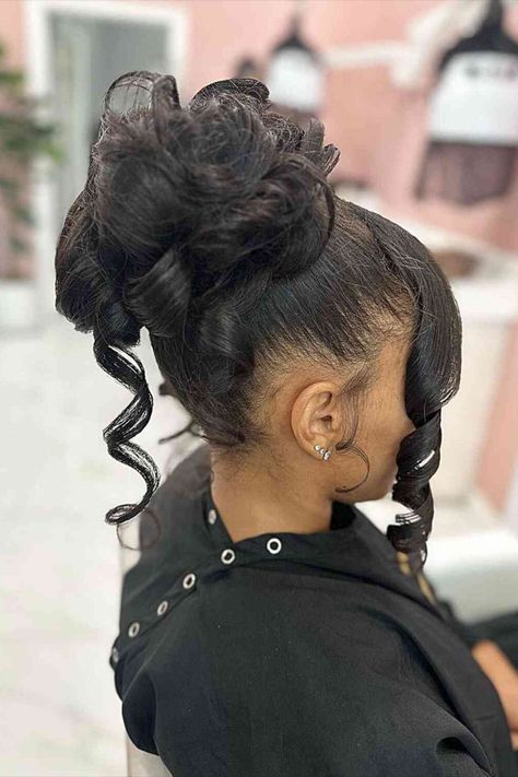 High Messy Updo Bun with Front Curls for Black Women High Hairstyles Bun, Elegant Buns For Black Women, Prom Bun Black Women, Frizzy Hair Hairstyles Black Women, Updo With Weave For Black Women, Messy Bun Updo Black Women, High Bun With Curls Hanging Down, Formal Updo Black Women, Wedding Hair Unique