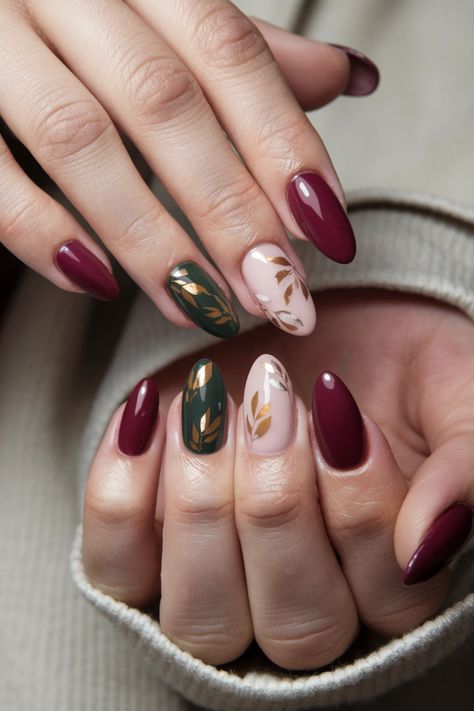 Embrace the beauty of the season with these fall nail ideas featuring mesmerizing gel nails adorned with intricate autumn leaves. The rich hues of red, orange, and gold encapsulate the essence of fall, making your nails a true seasonal statement. Perfect for cozy gatherings or weekend outings, these stunning gel nails will elevate your style while keeping your tips chip-free and glossy. Discover the magic of these fall nail ideas! #FallNailIdeas #GelNails #AutumnNails #NailArt Short Almond Nail Art Fall, Fall Leaf Designs For Nails, Red And Gold Design Nails, Gold Leaves Nails, Colourful Autumn Nails, Fall Jewel Tone Nails, Fall Leaves Nails Design, Fall Nails Leaves Autumn, Green And Brown Fall Nails