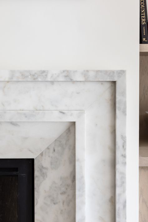 Intricate details on the marble slab fireplace of our Nellie Gail project. Simple Marble Fireplace Surround, Granit Fireplace Ideas, Carrara Marble Fireplace Surround, Fireplace Art Deco, Marble And Stone Fireplace, Granite Fireplace Mantle, Marble Fireplace Ideas Modern, Porcelain Fireplace Surround, Slab Fireplace Surround