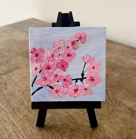 Hand painted 4x4in canvas in acrylics. Featuring pink cherry blossom branch. Small easel included. Llama Painting Canvases, Japanese Cherry Blossom Painting Acrylic, Mini Canvas Paintings Cute, Easy Quick Paintings Ideas, Easy Cherry Blossom Painting, Cute Small Canvas Painting Ideas, What To Draw On A Canvas, Simple Small Paintings, Cute Easy Paintings Simple