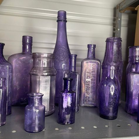 A set of 16 antique purple bottles and jars of varying sizes. Most pieces are free from chips and cracks, but most have a white haze to the bottle. I have been somewhat successful with using petroleum jelly in removing some of the haziness. California Fig Syrup bottle, Columbia Catsup bottle are a couple of the ones being offered in this healthy-sized collection.  A little background info on these purple bottles. Some, possibly all of these bottles were not originally purple / Amethyst. The colo Purple Bottles, Fig Syrup, Purple Bottle, Syrup Bottle, Antique Glass Bottles, Rustic Traditional, Petroleum Jelly, Purple Decor, Antique Perfume Bottles