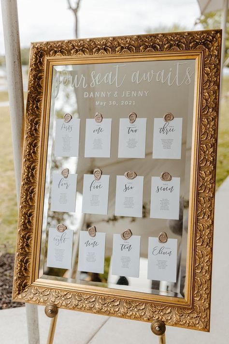 We love this boho/vintage seating chart displayed on a vintage mirror with wax seals holding the place cards. Wax adhesives linked here: https://rstyle.me/+MJPefpnIE2XrOCO35NmOZw https://thevictorianyoungsville.com/blog/f/jenny-dannys-vintage-wedding Wedding Signs For Seating, Table Placement Cards, Cute Place Cards Wedding, Mirror Ideas Wedding, Table Numbers Display Wedding, Seating Chart On Mirror Wedding, Table Numbers On Mirror, Wedding Table Banquet Style, Table Seating On Mirror