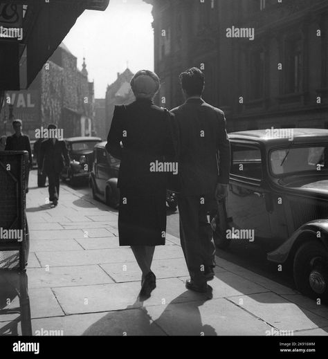 Download this stock image: 1940s couple. A man and a woman are seen from behind walking in a Brussel street. Brusells Belgium 1946. Kristoffersson V144-4 - 2K916WM from Alamy's library of millions of high resolution stock photos, illustrations and vectors. Brusells Belgium, 1940s Couple, 1920s Men, Cover Ideas, Image Processing, Picture Library, Vintage Men, Belgium, Art Ideas