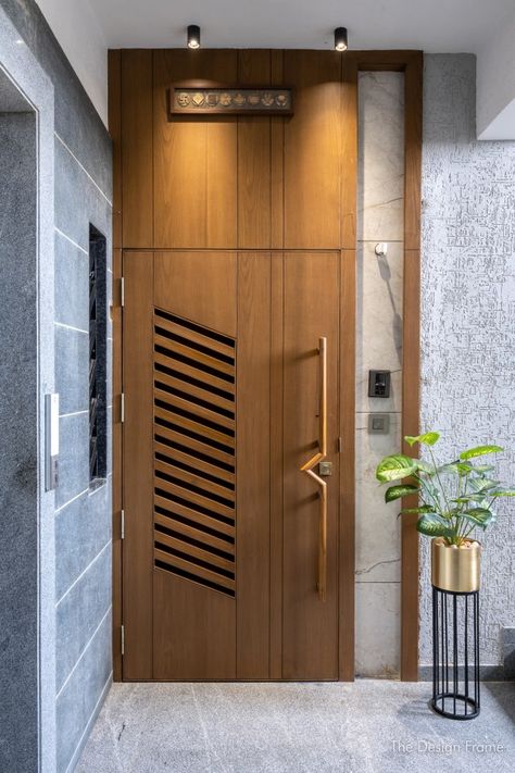 Elegant Apartment Space Designed With Ample Natural Light And Ventilation | The Design Frame - The Architects Diary Safety Door Handle Design, Main Door Lighting Ideas, Modern Door Frame Design, Door With Ventilation Design, Main Door Design Modern Front Entry Wood, Apartment Main Door Design, Sefti Door Design Modern, Door Ventilation Design, Safety Door Ideas