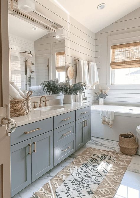 27 Beautiful and Soothing Coastal Bathroom Ideas 70 27 Beautiful and Soothing Coastal Bathroom Ideas Belgian Design Interiors, Bathrooms With Blue Cabinets, Coastal Shiplap Bathroom, Neutral Blue Bathroom, East Coast Bathroom, Christina On The Coast Bathroom, Blue Accent Bathroom, Couples Bathroom Ideas, Children’s Bathroom