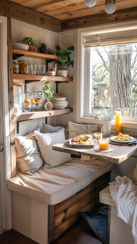 Cozy breakfast nook with natural sunlight, plush cushions, wooden table with breakfast spread, rustic shelves with plants and kitchen essentials. Breakfast Bench, Breakfast Nook Bench, Breakfast Spread, Interior Design Principles, Sustainable Interior Design, Starting Fresh, Rustic Wooden Shelves, Cozy Breakfast, Popular Interior Design