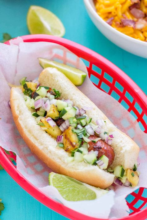 Hawaiian BBQ Hot Dogs will be your new cookout meal. Hot dogs are basted with BBQ sauce and topped with a grilled pineapple and cucumber salsa for a fresh, delicious take on a summertime classic! Bbq Hotdogs, Bbq Hot Dogs, Pineapple And Cucumber, Memorial Day Foods, Cucumber Salsa, Hot Dog Toppings, Grilling Essentials, Hawaiian Bbq, Hot Dog Recipes