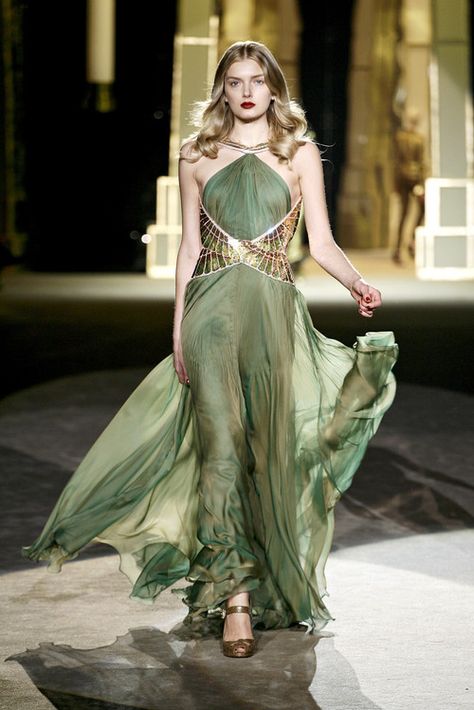 The dragon Rhaegal     Rhaegal has scales of bronze and moss green which, when catching the light, gleam like jade. His eyes are the bronze of polished shields and glow in their own heat. His flame is orange and yellow fire shot through with veins of green.  Roberto Cavalli F/W 2007 Green Runway Dress, Green Runway Fashion, Green Gold Dress, Green Runway, Green And Gold Dress, Grecian Dress, Roberto Cavalli Dress, Cavalli Dress, Runway Gowns