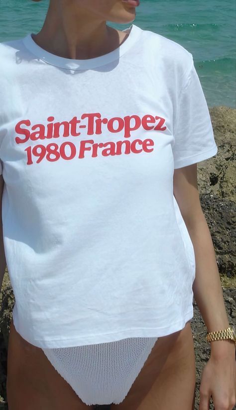 Catch those retro summer vibes with our 'Saint-Tropez 1980 France' tee! Perfect for adding a splash of vintage French chic to your beach adventures! Unisex soft cotton crew neck t-shirt featuring a red Saint Tropez 1980 France graphic printed on the front. Fabrics: 100% cotton, 6.1 oz Made in: LA French Riviera Style, T Shirt Aesthetic, Summer Graphic Tee, Graphic Tee Outfits, Retro Graphic Tees, Beach Adventure, Holiday Tops, Graphic Tees Vintage, Retro Summer