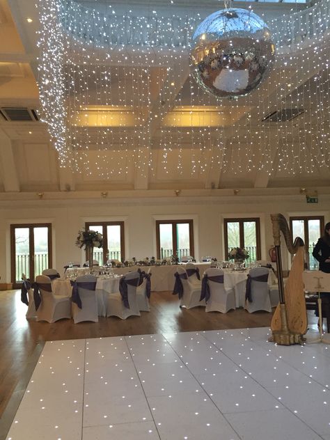 White glitter dance floor, fairy lights and glitter disco ball Glitter Dance Floor, Prom Dance Floor, Sweet 16 Dance Floor, Wedding Dance Floor Fairy Lights, Dance Floor Disco Ball, Wedding Dancefloor, School Dance Decorations, Wedding Dinner Table Setting, Twinkle Lights Wedding