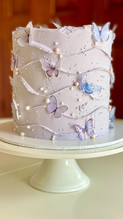 sweetbuttercreamco on Instagram: Butterfly cake #swirlycake #wavycake #swissmeringuebuttercream Decorated with wafer paper butterflies @zaharibydina & sprinkles by… Whimsical Butterfly Cake, Butterfly Decorated Cake, Cake With Butterfly Decorations, Butterfly Tiered Cake, Lilac Butterfly Cake, Lavender Butterfly Cake, Butterfly Bridal Shower Cake, Butterfly Themed Birthday Cake, Flower And Butterfly Cake