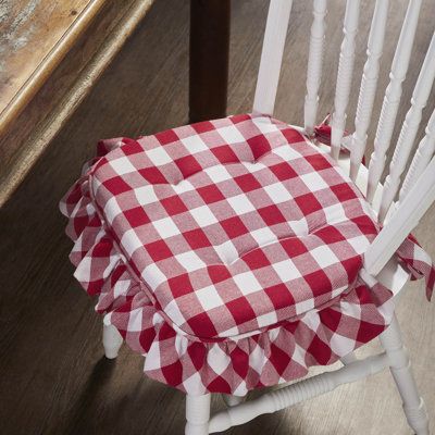 Elevate the comfort and style of your dining or kitchen chairs with the VHC Brands Chair Pad from the Annie Buffalo Check Collection. Measuring 16.5x18 inches, this chair pad embodies farmhouse and country aesthetics with its classic buffalo check pattern. Crafted with a twill weave and textured finish, it adds a touch of rustic charm to your indoor seating. Designed with ties, this chair pad securely fastens to your chairs, ensuring a snug and stylish fit. Its plaid design is both versatile and Buffalo Check Shower Curtain, Outdoor Chair Pads, Ribbon Display, Room Maker, Folding Towels, Diy Kitchen Table, Primitive Santa, Wooden Barn, Vhc Brands