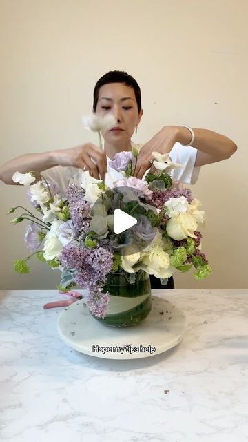 NYC Wedding and Events Florist on Instagram: "Part 3 Purple. The final and largest one.  ☑️Recipe: hydrangea, rose, spray rose, lilac, snowball viburnum, dusty miller, lisianthus, sweet peas, and anemones ☑️Sprite + bleach combo = flower food + bacteria killer ☑️Grid the vase with 5 initial stems of rose/spray rose ☑️Hydrangeas act to fill in the spaces but keep them loose ☑️Clean off the little leaves so the leaves don’t compete with the blooms in the arrangement.  ☑️Let each flower breathe and shine / have their moment ☑️Like, Share, Follow for more flower arranging   #floristsofinstagram #flowerarrangement #flowerarranging #flowerclass #rachelchofloral" Hydrangea Flower Arrangements Vase, Spray Roses Arrangement, How To Arrange Flowers, Hydrangea In Vase, Snowball Viburnum, Hydrangea Flower Arrangements, Floral Designs Arrangements, Hydrangea Vase, Rose Spray