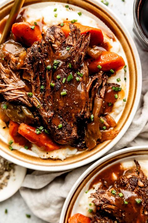 You don't need an expensive cut of beef to make a restaurant-worthy meal – this Red Wine Braised Beef recipe is proof! Slowly simmer beef chuck roast with red wine, vegetables, & herbs until it transforms into a succulent centerpiece complete with a built-in red wine sauce. Serve with creamy mashed potatoes for the best cozy dinner! (Slow cooker/Crockpot & Instant Pot directions provided.) #redwinebraisedbeef #redwinebeefroast #braisedbeef ##braisedbeefroast #beefroast #beefrecipes #dinnerideas Red Wine Beef Roast, Cooking Chuck Roast, Roast With Red Wine, Red Wine Braised Beef, Wine Braised Beef, Braised Beef Recipes, Crockpot Roast Recipes, Chuck Roast Recipes, Best Pot Roast