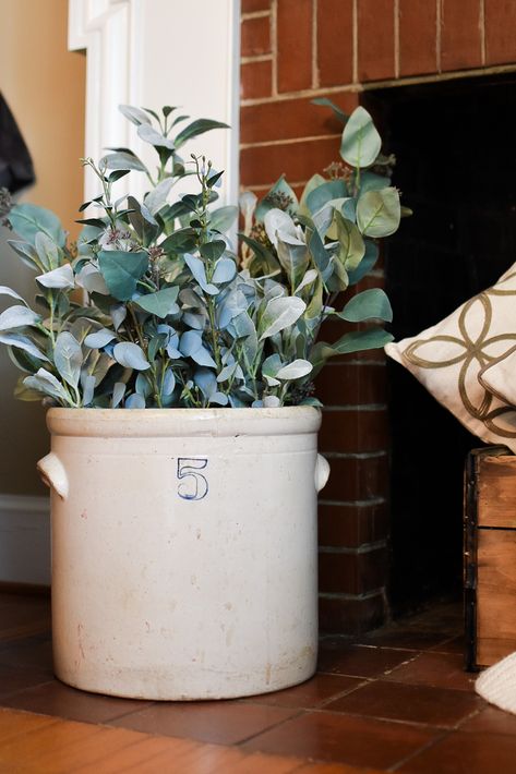 #farmhouse #farmhousedecor #dairy #crock #hearth #fireplace #fireplacedecor #fireplaceideas #plants #vintage #rustic #rustichomedecor #rusticdecor Farmhouse Pots For Plants, Crock Vintage Decor, Flowers In Crocks Ideas, Crock Floral Arrangement, How To Decorate A Crock, Crock Jug Decor Ideas, How To Decorate Crocks, Organic Farmhouse Decor, Crock Ideas Decor Farmhouse Style