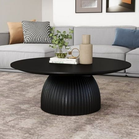 This coffee table brings sleek style and warm wood to center stage. It's made from engineered wood. This table features a smooth, hourglass-style silhouette  rounding out your space while offering visual dimension. Stylish and versatile, it complements contemporary and industrial dcor styles alike. Place it in front of your loveseat or sofa, and use it to rest books, beverages, and display items. Then, sit back and watch as it ties your space together. Elevate your interior with a touch of modern industrial allure through this captivating set of Round Accent Nesting Side Coffee Tables. This collection promises to infuse your space with contemporary flair while delivering unparalleled functionality. Crafted with an eye for uniqueness, these tables embody both style and utility, making them Black Center Table Decor, Small Circle Coffee Table Decor, Circle Coffee Table Styling, Black Coffee Table Living Room, Round Coffee Table Styling, Circle Coffee Tables, Black Coffee Table, Coffee Table Black, Round Wood Coffee Table