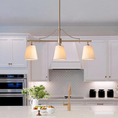 Modern meets classic, this stunning luminary with gold finishes, presents a simple and vintage look. The stylish kitchen island pendant chandelier does not take up any valuable space. With its unique design and glamorous vibe, it cannot be ignored in many places including the dining room and the bedroom. | House of Hampton® 3-Light Shaded Classic / Traditional Chandelier Metal | Wayfair Chandelier Above Island, 3 Light Kitchen Island Pendant, Kitchen And Dining Room Open Concept, Vintage Island Lighting, Single Light Over Kitchen Island, Small Island Lighting, Over Table Light Fixture, Dining Table Lighting Modern, Brass Dining Room Chandelier