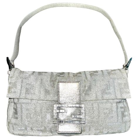 Rare FENDI shoulder bag in the famous Zucca print with a twist - in shiny lurex! Details: Fendi Baguette with the famous FF Zucca logo print Fendi FF Zucca canvas with a glitter effect Shiny metallic lurex material - glacé lustrous shine depending on light - amazing! Crystal embellished FF Fendi logo closure Adjustable shoulder strap Side Metal detailing with engraved Fendi logo Satin internal lining Internal zip fastening pocket Metal plaque with engraved Fendi logo Made in Italy All pictures t Fendi Shoulder Bag, Hermes Kelly Bag, Vintage Fendi, Fendi Logo, Fendi Baguette, Couture Vintage, Bags Designer Fashion, Cute Bags, Fendi Bags