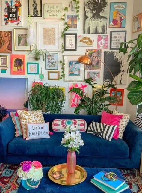 a maximalist living room with neutral walls, a blue sofa and a matching ottoman, a colorful gallery wall and lots of potted plants Maximalist Living Room, Funky Living Rooms, Blue Couch, Maximalist Interior, Colorful Apartment, Interior Design Per La Casa, Apartment Decoration, Funky Home Decor, Colourful Living Room