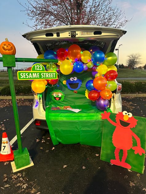 Sesame Street Trunk or Treat for my kid’s school included a Sesame Street sign, full sized Elmo plus Cookie Monster, Big Bird and Oscar faces all made out of colored craft foam and hot glue. Street stand was made from foam blocks and leftover fabric spools. Sesame Street Truck Or Treat, Cookie Monster Trunk Or Treat Decor, Trunk Or Treat Ideas Sesame Street, Sesame Street Trunk Or Treat Ideas For Cars, Elmo Trunk Or Treat Ideas, Trunk Or Treat Preschool Ideas, Trunk Or Treat Daycare, Sesame Street Halloween Decorations, Oscar The Grouch Trunk Or Treat