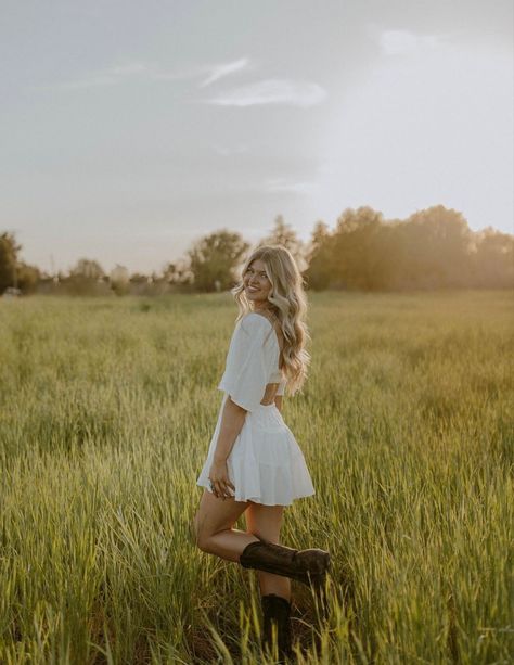 Women’s Poses, Western Style Senior Photos, Senior Outdoor Pictures, Flower Field Photoshoot Outfits, White Dress With Cowboy Boots Senior Photos, Girl Senior Portraits Outfits, Field Senior Photoshoot, Open Field Photoshoot Poses Women, Senior Poses Field