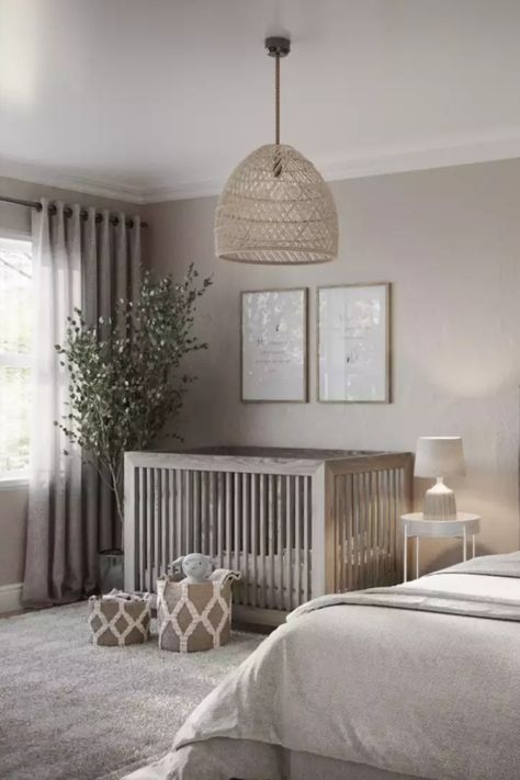 Nursery features a neutral color palette, a wooden crib, and toy baskets. Contemporary Modern Nursery, Modern Transitional Nursery, Grey Nursery Wallpaper, Contemporary Nursery Neutral, Nursery Ideas Transitional, Transitional Style Nursery, Modern Minimal Nursery, Grey And Cream Nursery, Beige And Grey Nursery