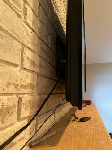 How to Mount a TV Over a Brick Fireplace - Hide Tv Cords Above Fireplace, Hiding Wires Mounted Tv, Tv On Brick Fireplace, Hiding Tv Cords On Wall, Hide Tv Cords, Tv Above Fireplace, Fireplace Tv Mount, Tv Cords, Tv Over Fireplace