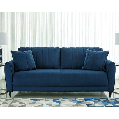 A brilliant take on urban chic styling, this sofa in vibrant blue makes high design highly affordable. Distinctive elements include quilted channel stitching for clean-lined allure and a velvety soft fabric you'll love living with. Sculptural track arms up the wow factor. If you’re looking for big style on a more modest scale, you’re sure to appreciate this sofa’s space-conscious 82" wide profile. | Ebern Designs Bynoe 82" Square Arm Sofa 36.0 x 82.0 x 38.0 in | C002241294 | Wayfair Canada Ashley Sofa, Blue Couches, High Design, Ashley Furniture Homestore, Estilo Chic, Blue Sofa, Velvet Sofa, Vibrant Blue, Urban Chic