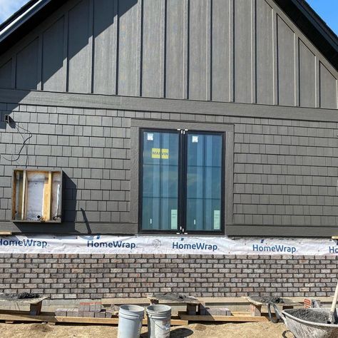 Board And Batten Siding Garage, Board And Batten Exterior With Brick, Dark Board And Batten Exterior, House Siding Styles, Dark Farmhouse Exterior, Brick And Board And Batten Exterior, Vertical Siding Exterior, Dark Farmhouse, Dark Industrial