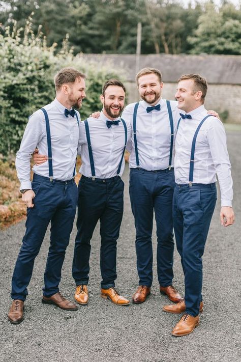 a stylish groom's outfit with navy pants and suspenders, light blue shirts, navy bow ties, brown shoes Smart Casual Groom, Usher Outfits, Navy Blue Groomsmen, Navy Blue Wedding Theme, Dress Code Outfits, Groomsmen Dress, Bow Tie Groomsmen, Blue Groomsmen, Navy Groom