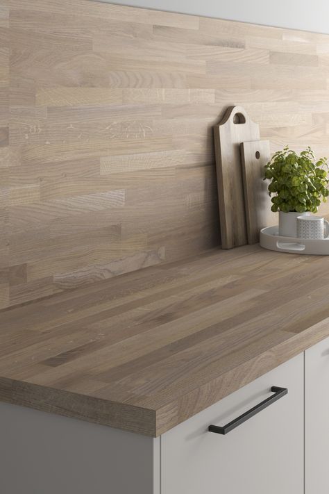 Looking for kitchen backboard ideas? Our Authentic Oak Block Effect Laminate Backboard is perfect for your kitchen backboard inspiration. Pair with a light grey kitchen, black kitchen hardware and a matching oak worktop for a traditional kitchen design twist on a modern kitchen design. White Kitchen Ideas With Wooden Worktops, White Kitchen Wooden Worktop Black Handles, Cashmere Kitchen Wood Worktop, Light Oak Worktop Kitchen, Light Grey Kitchen With Wooden Worktop, Wooden Splashback Kitchen, Wooden Kitchen Backsplash, White Gloss Kitchen Wood Worktop, Grey Kitchen Wood Worktop