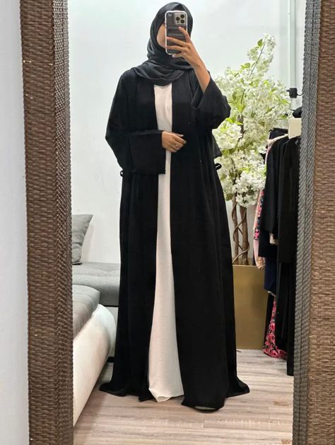 Elevate your modest wardrobe with our collection of open abayas. With a belt to cinch the waistline, this abaya is perfect for those who prefer a more fitted look. Available in four different colors, this versatile piece can be worn for any casual occasion. Season: All Seasons Stretch: None Occasion: Casual The long flare sleeves add a touch of elegance to the overall design and provide ample coverage. This open abaya is perfect for layering over your favorite outfits while still maintaining modesty. Incorporate this stylish piece into your everyday wardrobe and effortlessly enhance your Muslim fashion attire. Elevate your modest wardrobe with our collection of open abayas. With a belt to cinch the waistline, this abaya is perfect for those who prefer a more fitted look. Available in four Open Abayas, White Abaya, Abaya Outfit, Modest Wardrobe, Black Abaya, Open Abaya, Black Layers, Flare Sleeves, Muslim Fashion Outfits