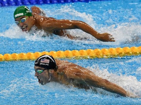 Michael Phelps' rival Chad le Clos looks at Phelps mid-race.