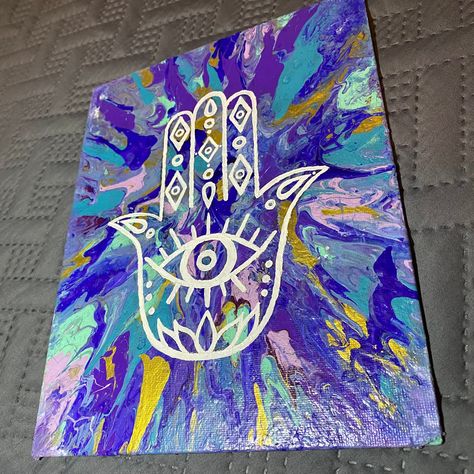 This work features a hamsa hand design painted in white over a colorful abstract background. Background was created using acrylic paints and various canvas spinning and air blowing techniques. Painting is on an 8x10 canvas board and comes unframed. Hamsa Canvas Painting, Spiritual Painting Ideas, Hamsa Hand Painting, Spiritual Paintings Easy, Paintings Spiritual, Hamsa Painting, Hamsa Hand Art, Hamsa Art, Tiny Paintings