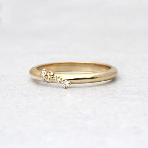 Ella flawlessly combines perfection and asymmetry. A tiny cluster of diamonds on a slim gold band. This ring represents a journey interrupted by clusters of magical moments.DETAILS- Cultivated, conflict free diamonds- Approximately .065 CTW- Band is approximately 2.1mm width x 1.7mm height- Handmade in our New York City studioSTONESWe are happy to offer alternative stones including natural diamonds. Please message/email us for details and pricing.VARIATIONS/CUSTOMIZATIONSWe can customize this ri Wedding Band Small Diamonds, Embedded Diamond Ring, Minimal Engagement Ring, Alternative Ring, Cluster Diamond Ring, Dainty Wedding Band, Solid Gold Band, Cluster Rings, Magical Moments