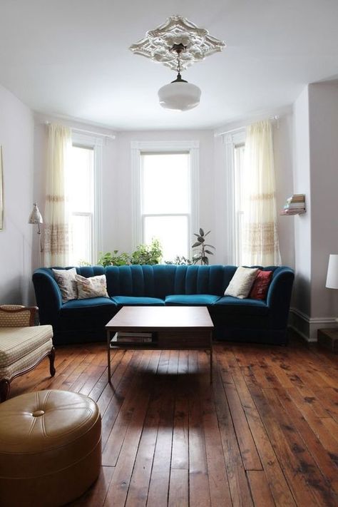 4 Reasons Why A Bay Window is Right For Your Home, blue velvet sofa Sectional In Bay Window, Bay Window Couch Ideas, Bay Window Ideas Living Room Furniture Layout, Restored Floorboards, Shell Couch, Living Room With Bay Window Layout, Bay Window Living Room Layout, Window Couch, Couch Redo