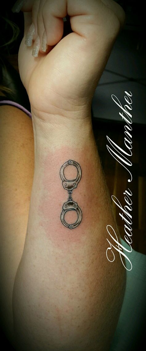 Handcuff tattoo design. Thank u Mande! Animal Control Officer Tattoos, Handcuff Tattoo Small, Police Tatoos Ideas, Female Law Enforcement Tattoos, Handcuffs Tattoo Design, Police Officer Tattoos Female, Handcuff Tattoo For Women, Cop Wife Tattoo, Small Police Tattoo Ideas