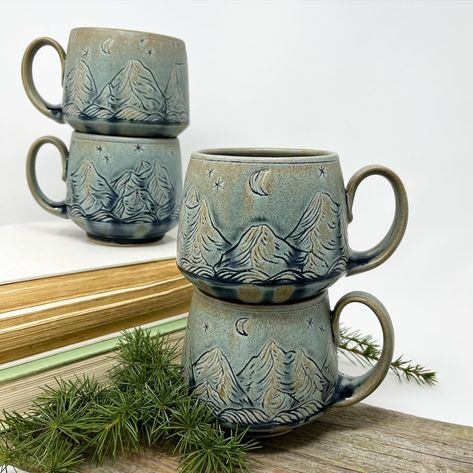 I'm planning to make another batch of these mountain mugs soon-- I'm putting handles on the mug forms today, and in a couple days they will be ready to carve! I love the subtle way the Blue Ridge glaze highlights this carved design-- it's a softer look than my blue/gray inlay, and sometimes that is exactly what my eye craves. Mountain Mug Pottery, Mug Forms, Mountain Mugs, Slab Mug, Mountain Mug, Mug Pottery, Pottery Ideas, Blue Ridge, Blue Gray