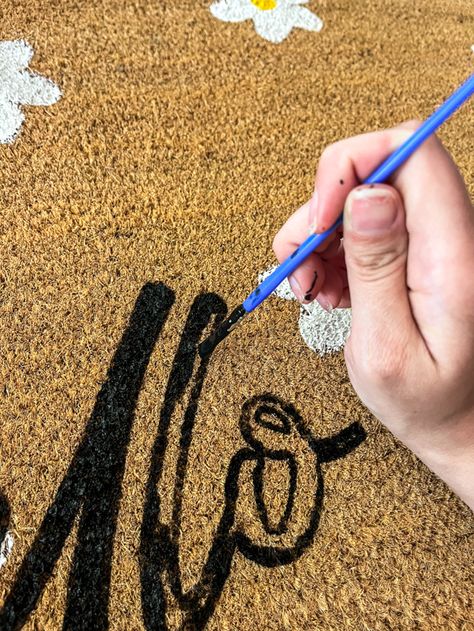 How to Make Your Own Doormat Using Acrylic Paint - Simply Secen Diy Painted Fall Doormat, Diy Personalized Doormat, Painting An Outdoor Rug, Sip And Paint Halloween Door Mat, How To Paint A Rug Porch, Fall Crafts Easy Adults, Halloween Doormat Painting Party, Christmas Rugs Outdoor Diy, How To Paint A Rug Diy