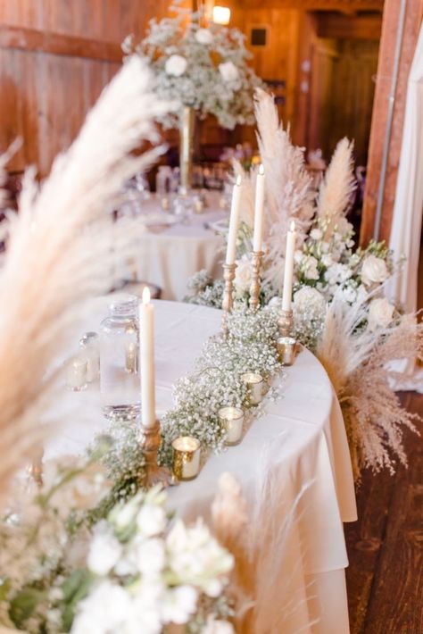 Rustic Barn winter wedding with roses, babies breath and pampas grass! Rustic touches with candles everything making it look elegant Pampas Grass And Gypsophila Wedding, Gypsophila And Pampas Wedding, Pampas Grass And White Roses, Pampas Grass Winter Wedding, Green And Gold Decor, Beach Autumn, Taper Candles Wedding, Wedding Pampas, Lots Of Candles