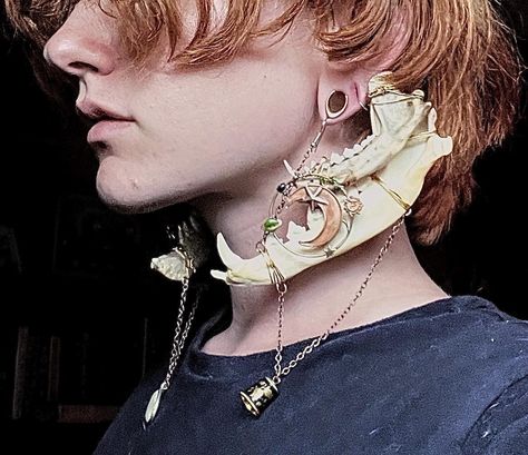 These double gauge hangers/earrings are made from naturally sourced jawbones collected by the maker. They also feature two distinct pendants that display angelic and astrological themes to create a very whimsical, elegant piece with a dark undertone. They are recommended to be worn with silicone ring gauges to create a more comfortable experience but can be worn with metal, or bare ears. They are designed for gauged ears and create a weight for the stretched lobe, but could potentially be worn w Character Design Jewelry, Unique Accessories Fashion, Gauged Ears With Piercings, Warlock Jewelry, Jaw Jewelry, Double Pierced Ears, Ornamental Jewelry, Earrings Reference, Bone Fashion