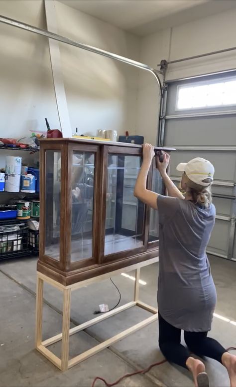 This upcycled DIY curio cabinet is a high-end dupe, but cost just $112 | Real Homes Curio Cabinet Jewelry Display, Add Legs To China Cabinet, Diy Glass Display Cabinet, Antique Cabinet Styling, Display Case Makeover, Refurbished Glass Cabinet, Diy Glass Display Case, Curio Cabinet Makeover Modern, Repurpose Curio Cabinet