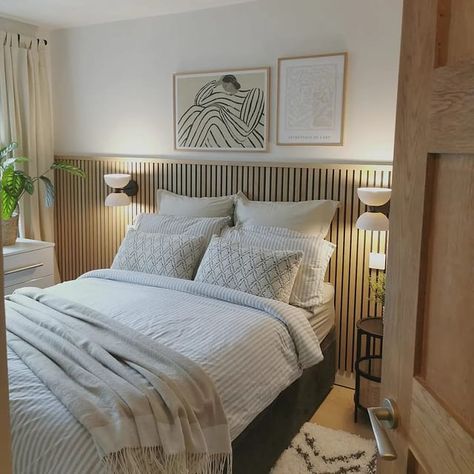 A Scandinavian getaway inspired bedroom in Boothstown.We added midi oak slat paneling on the bedhead wall, a fresh coat of paint, gorgeous light sconces, linen drapes, and all important plants and cosy textures for a hygge feel.Swipe to the end to see the 'before'naturewalluk Panelling Bed Headboard, Wood Panel Master Bed, Bedroom Wooden Panelling Accent Walls, Bedroom Slat Panelling, Slat Wall Panelling Bedroom, Cladded Bedroom Wall, Bedroom Slatted Wall, Bedroom Ideas Black And Cream, Wooden Panel Behind Bed